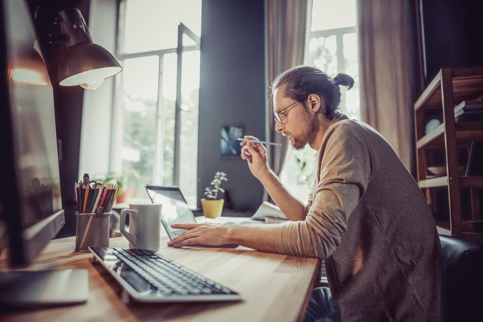 Young male working from home on laptop