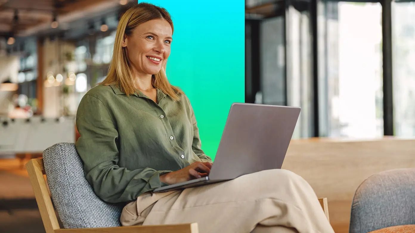 woman sitting in a chair working on her laptop