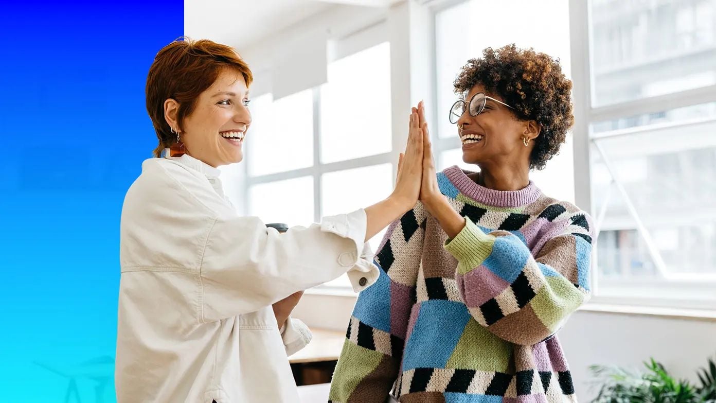 two woman giving each other a high five